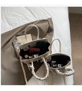 Internal view of cream leather mini handbag showing space for phone and perfume