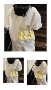 Macro detail of yellow litchi grain leather mini bag with silk scarf on the handle