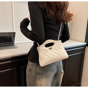 Detailed back view of a white quilted crossbody bag with silver chain strap and metal lock