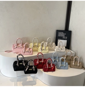 Variety of small lychee grain leather handbags with printed silk scarves on handles