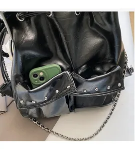 Detail view of the large capacity shoulder bag showing a functional pocket holding a smartphone