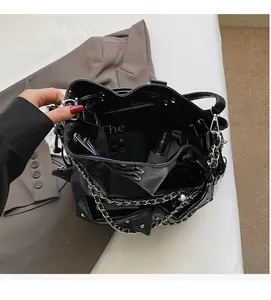 Top view of spacious black glossy bucket bag interior showing phone and daily essentials