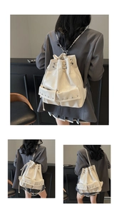 Detail of off-white glossy faux leather backpack with silver chains and rivet accents