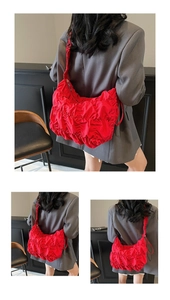 Detail of red pleated hobo bag showing lightweight nylon fabric and soft textures