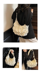 Detailed close-up of white pleated cloud bag showing soft texture and gathered shoulder strap