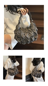 Detailed view of dark grey pleated tote bag featuring ruched fabric texture and large capacity