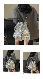 Close-up of metallic silver bucket bag featuring rivet pockets and drawstring closure