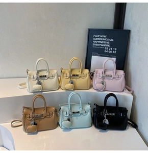 Mini Kelly-style handbags in six pastel colors featuring metal buckle and heart charms