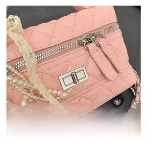 Detail of pink quilted leather handbag with premium silver metal clasp and chain strap