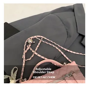Detail of pink quilted bag showing the adjustable golden ball and chain strap