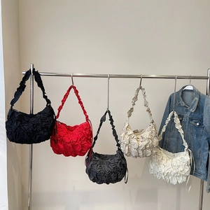 Minimalist cloud dumpling shoulder bags in multiple colors displayed with denim jacket
