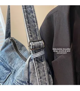 Close-up of adjustable strap with gun-metal buckle on denim tote bag for women