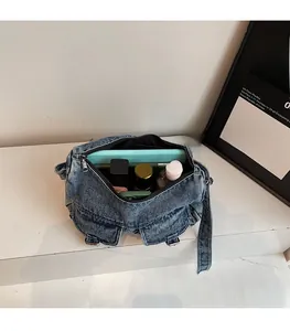Spacious interior of blue denim motorcycle bag with mint green lining and pockets