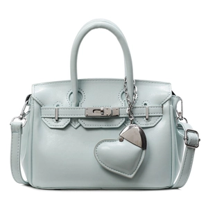 Light blue Kelly style handbag with a large heart pendant and detachable shoulder strap