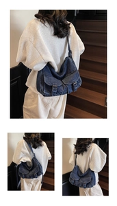 Detail of dark blue denim motorcycle bag showing buckle flap pockets and strap