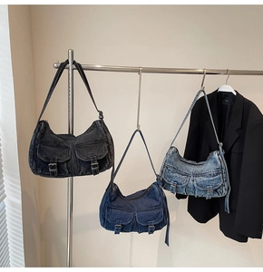 Detailed view of vintage denim shoulder bags with metal buckles and multiple pockets