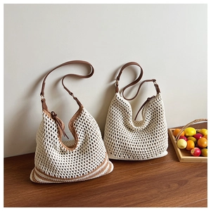Detail of hollow woven tote bags with leather shoulder straps and net texture