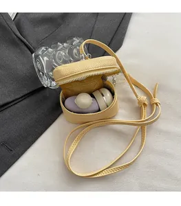 Detailed interior of a bright yellow pebble leather mini bucket bag with smooth zipper closure