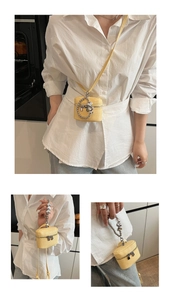 Detail view of yellow lychee leather mini bag with beaded metal chain and silver zipper
