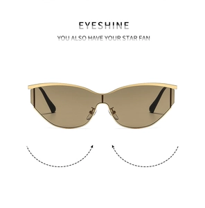 Detail of Y2K cat-eye sunglasses with gold metal frame and dark brown tinted lenses