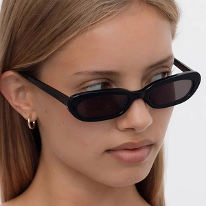 Vintage black oval cat eye sunglasses with dark lenses for women in street style