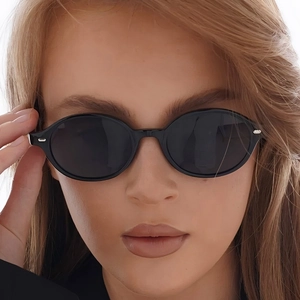Retro oval black sunglasses with UV protection lenses and silver rivet accents