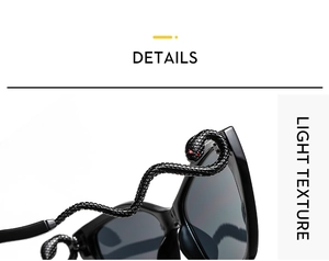 Détail de lunettes de soleil œil-de-chat noires avec branches en forme de serpent et yeux rouges