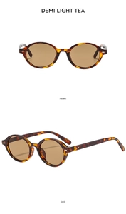 Detail view of oval retro sunglasses featuring tortoiseshell frames and tea-colored lenses