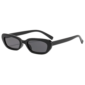 Vintage black oval cat-eye sunglasses with thick frame and dark grey lenses on white background
