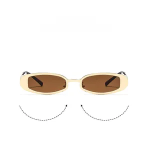 Macro detail of Y2K vintage oval sunglasses with metallic gold frame and brown lenses