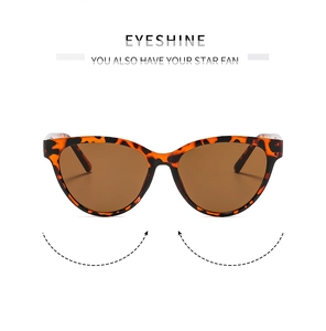 Detail of tortoise shell cat eye sunglasses with brown lenses and metal hinges