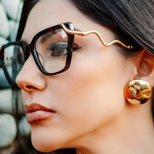 Fashionable square tortoiseshell sunglasses featuring detailed golden snake temple accents