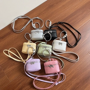 Mini crossbody bags in seven colors with heart beaded handles and lychee grain leather texture
