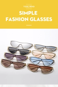 Detail of colorful trendy cat-eye sunglasses with golden metal frames in various shades