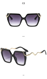 Detail of square sunglasses featuring golden snake-shaped temples and purple gradient lenses