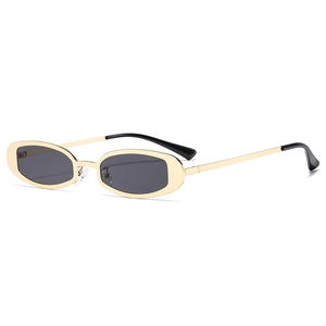 Retro Y2K oval narrow gold metal sunglasses with dark lenses for a vintage punk style