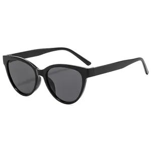 Fashionable black cat-eye sunglasses with dark grey UV lenses on a white background