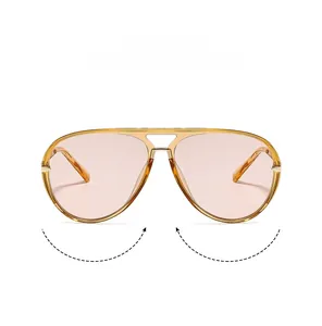 Detail view of transparent amber aviator sunglasses with dual bridge and pink lenses