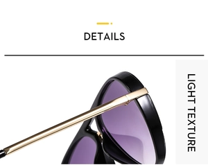 Macro detail of glossy black frames with gold metal temples and light texture