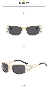 Detail of Y2K metallic rectangle sunglasses with hollow geometric grid design and gray lenses