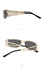 Detail view of gold Y2K sunglasses with hollow geometric woven temples and dark lenses