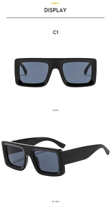 Close-up front and side view of thick black rectangular frames with dark blue lenses