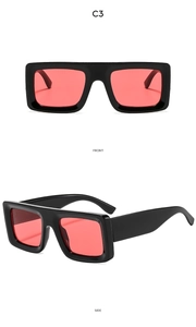 Detail view of square thick frame sunglasses with C3 red translucent lenses and side temple