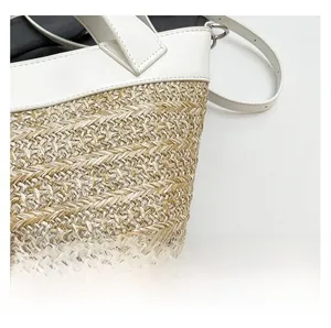 Detail of woven straw texture and white leather handle on summer beach bucket bag