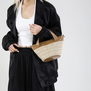 Woven straw bucket bag with brown leather trim and handles for women's summer beach style