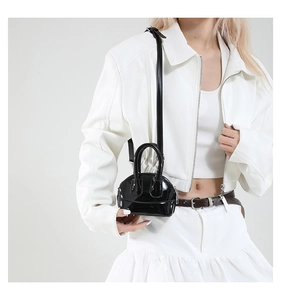 Mini sac bandoulière noir en cuir verni porté par un mannequin pour montrer les dimensions