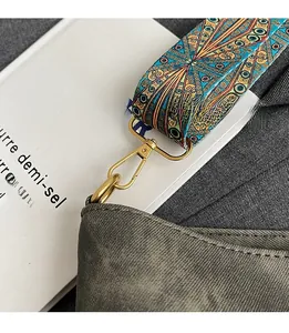 Detail of bohemian patterned strap with premium gold hardware and grey textured tote bag