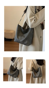 Detail of dark grey retro hobo bag with geometric wide strap and city commuter style