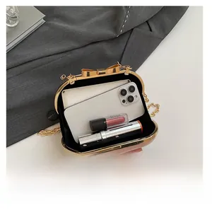 Pink evening clutch showing interior space for smartphone and makeup items