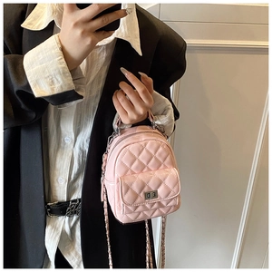 Detail showing pink quilted leather backpack with metal turn-lock and chain strap